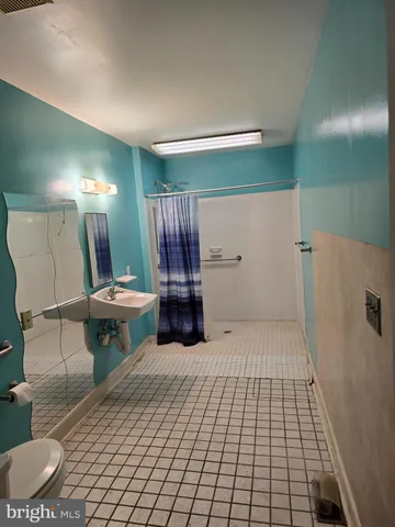 a view of a hallway and a dining room with wooden floor
