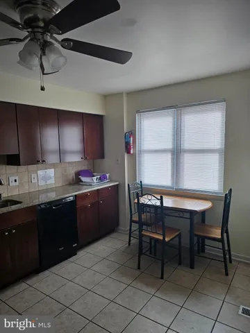 a kitchen with a table chairs sink and cabinets