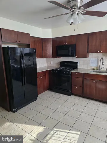a kitchen with stainless steel appliances granite countertop a sink counter space cabinets and a sink