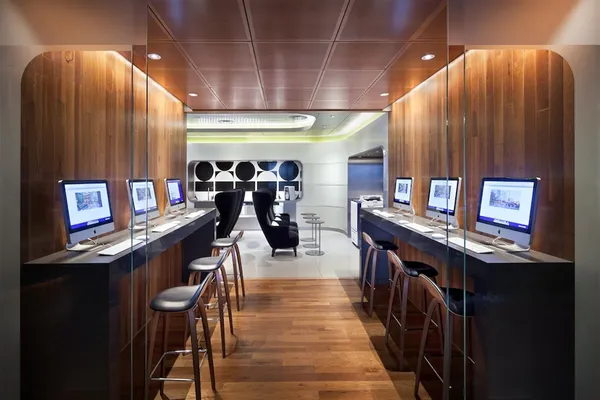 a room with lots of potted plants pool table and chairs