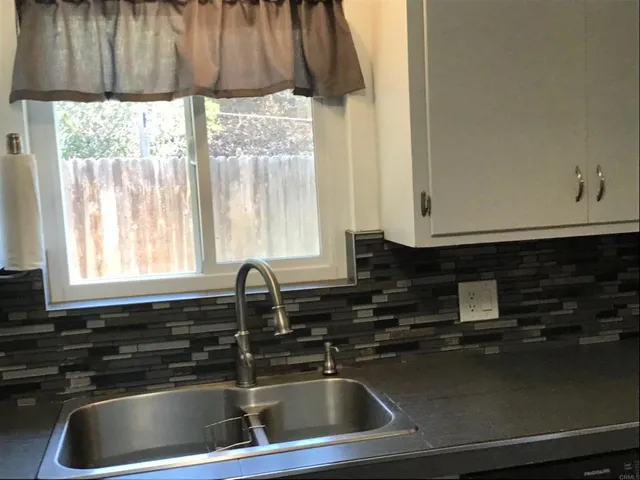 a kitchen with a sink and a window