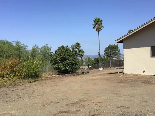 a view of a house with a wooden fence
