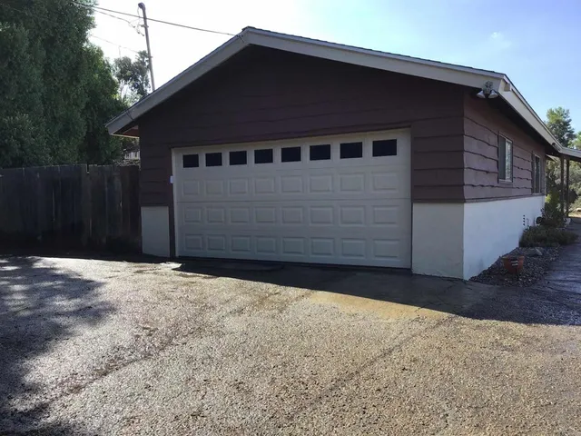 a view of a covered with trees in the background