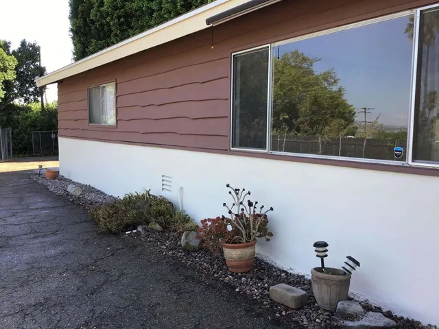 a side view of a house with sitting area