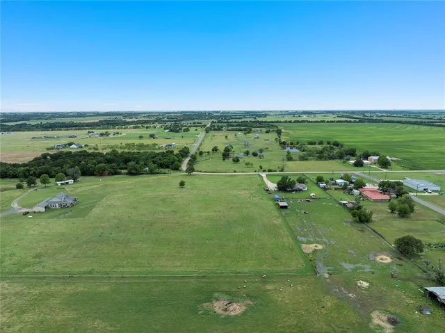 a view of a green field with clear sky