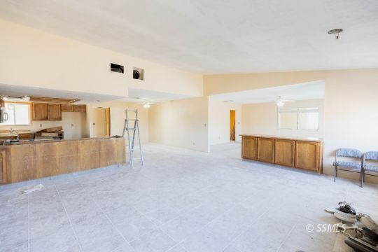 1653 South Fire Opal Street Ridgecrest, CA 93555 - Photo 12 of 28 a view of a livingroom with furniture and a kitchen