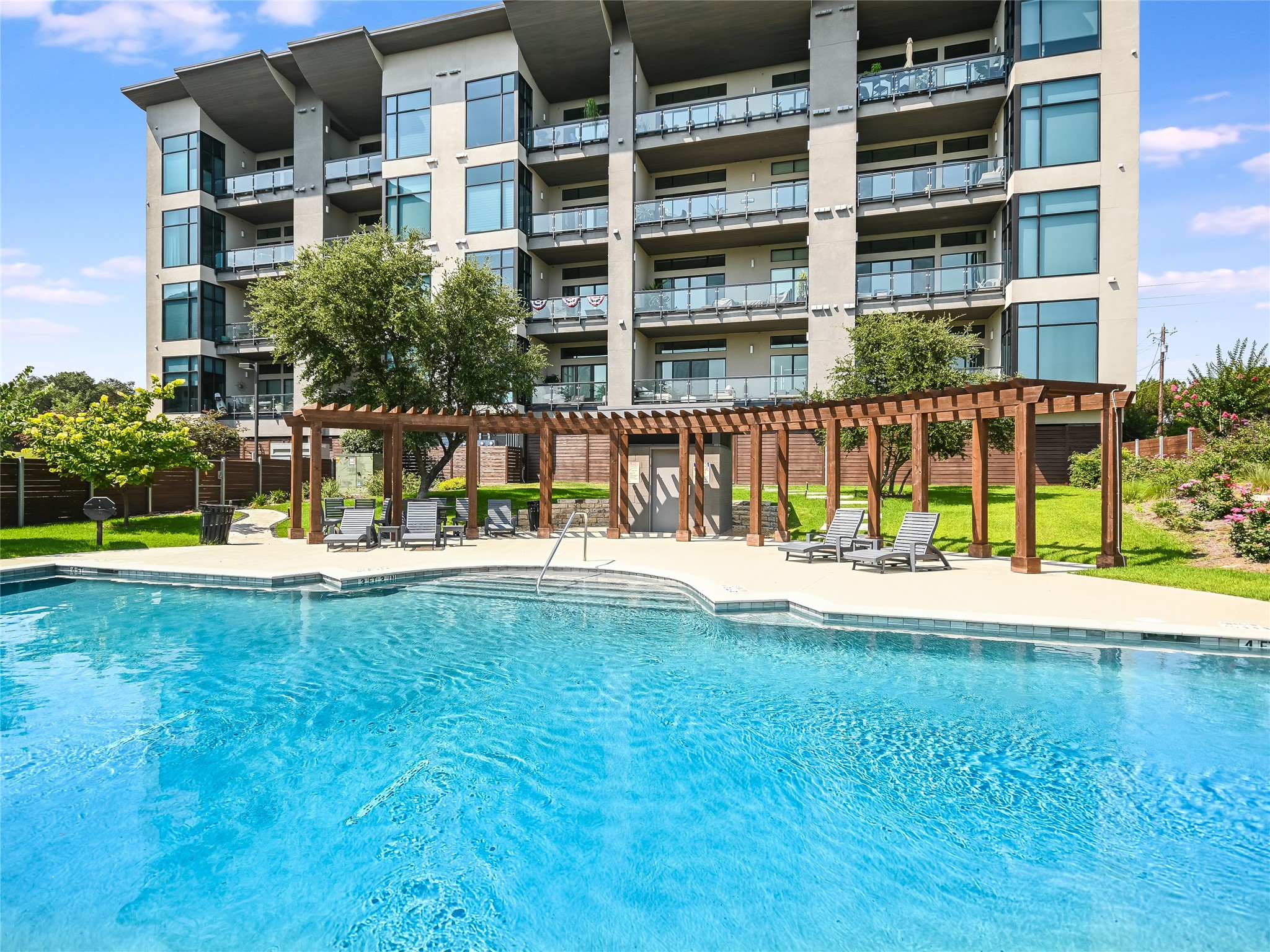 5921 Hiline Road, Unit 2403 Austin, TX 78734 - Photo 20 of 35 The Waterfall pool comes with lawn chairs, expansive pergola, cabana bathroom, and grills.