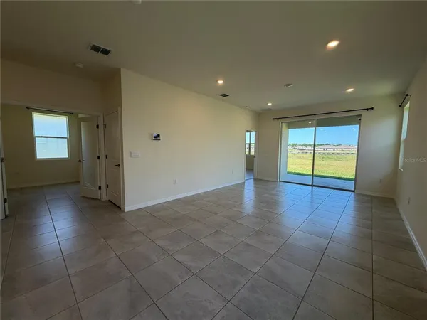 a view of hallway with a window and chandelier