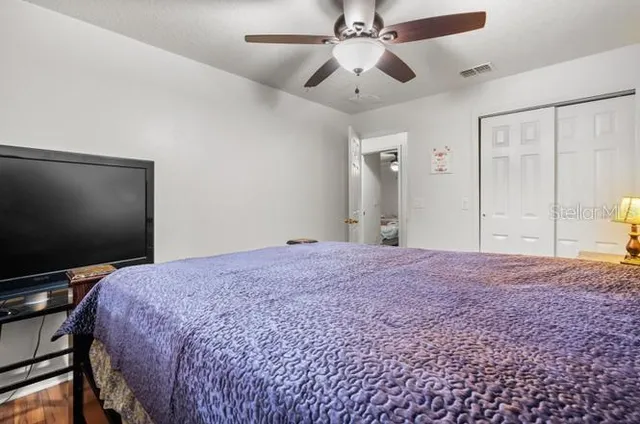 a bedroom with a bed and a flat screen tv