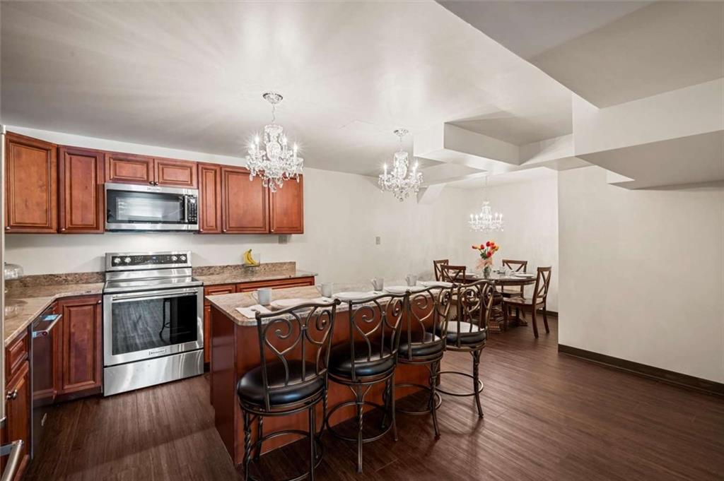 1702 Coulter Road Apollo, PA 15613 - Photo 24 of 50 a kitchen with stainless steel appliances granite countertop a stove top oven a sink dishwasher a dining table and chairs with wooden floor