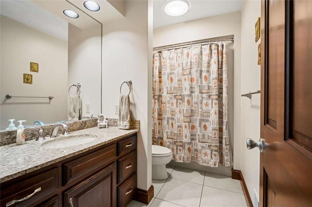 1702 Coulter Road Apollo, PA 15613 - Photo 5 of 50 a bathroom with a granite countertop sink a toilet a mirror and shower