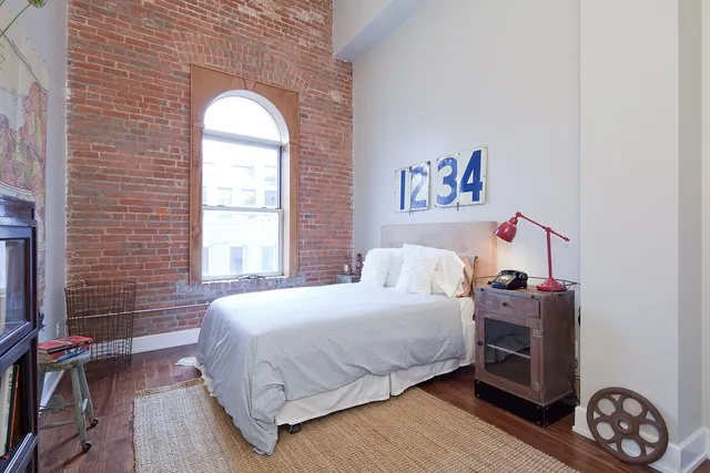 a bedroom with a bed and a window