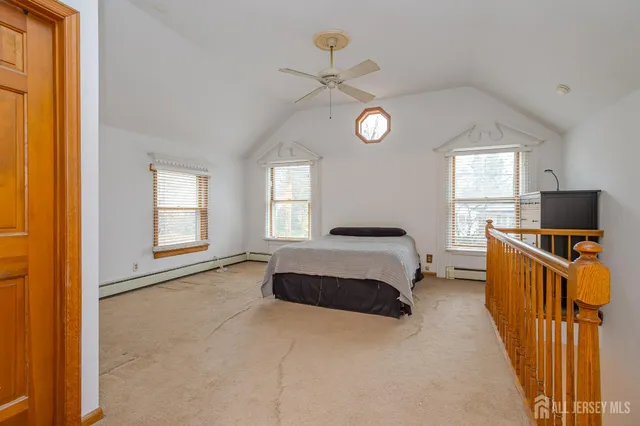a bedroom with a bed and a television on desk