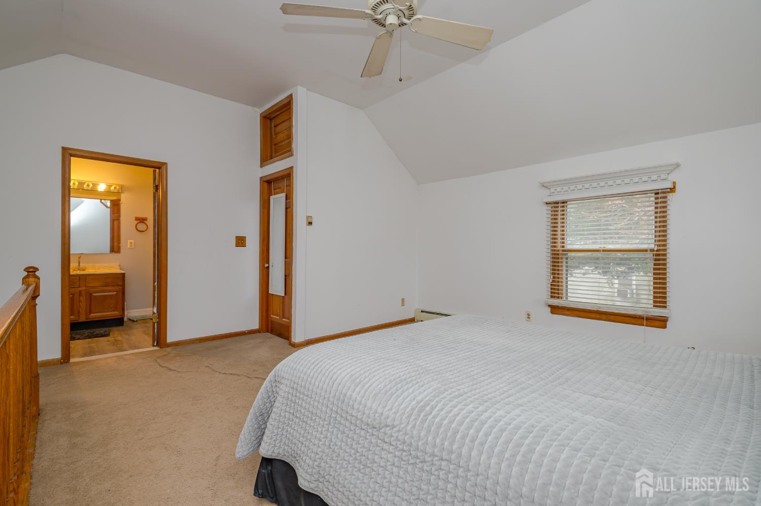 205 Main Street Spotswood, NJ 08884 - Photo 14 of 22 a bedroom with a bed and a chandelier