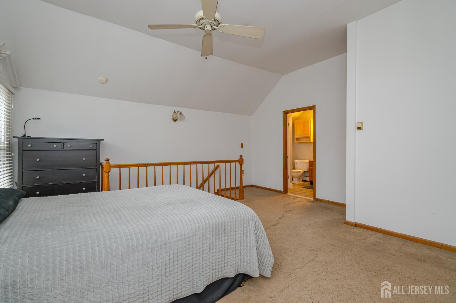 205 Main Street Spotswood, NJ 08884 - Photo 16 of 22 a bed room with a bed and a dresser