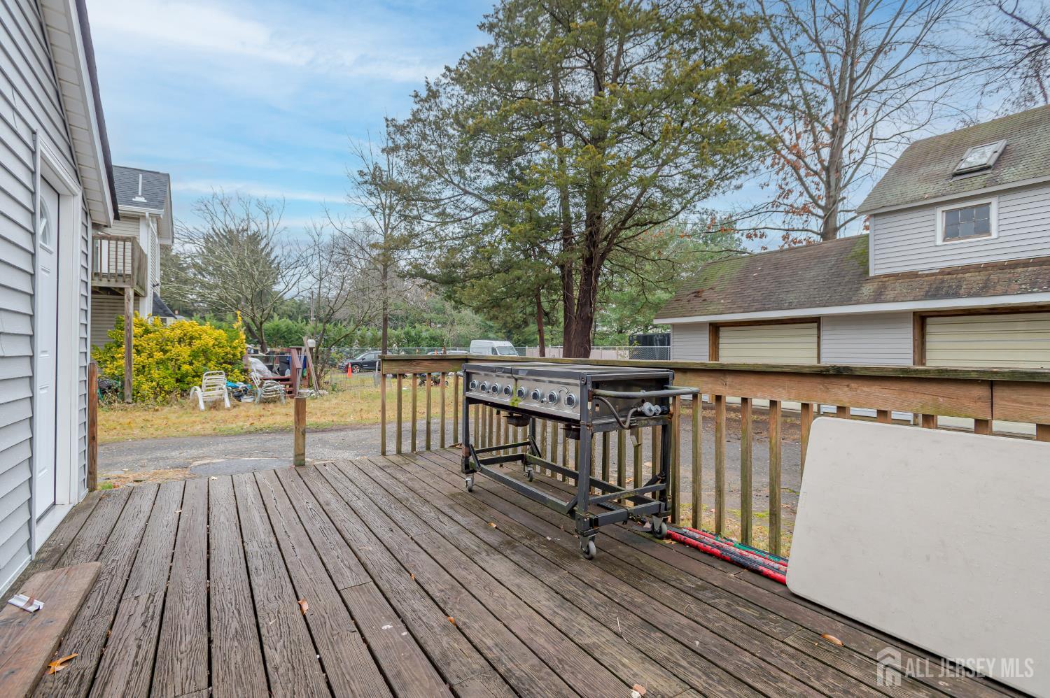 205 Main Street Spotswood, NJ 08884 - Photo 18 of 22 a view of a roof deck with wooden floor and fence