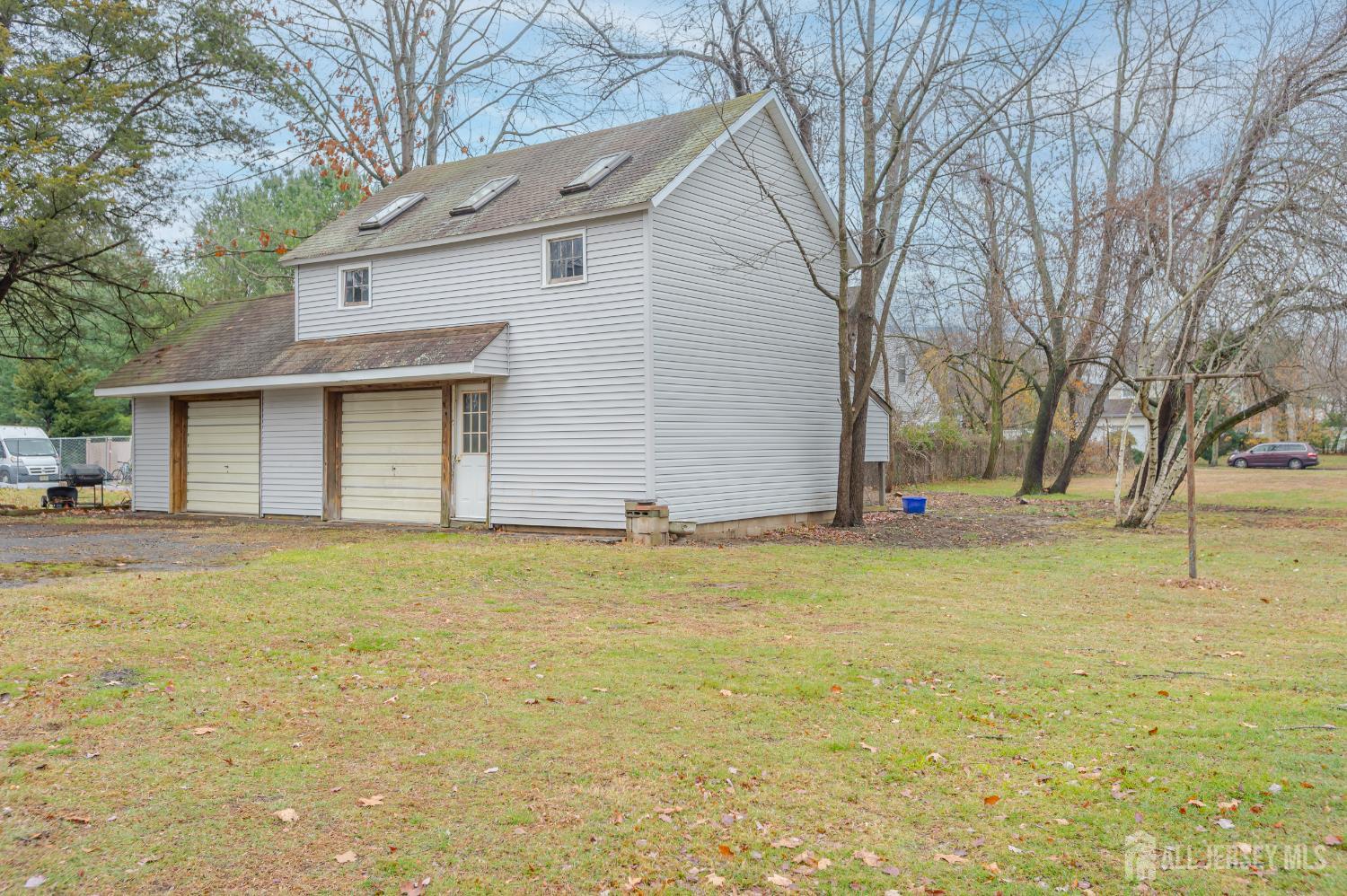 205 Main Street Spotswood, NJ 08884 - Photo 3 of 22 a backyard of house with large trees
