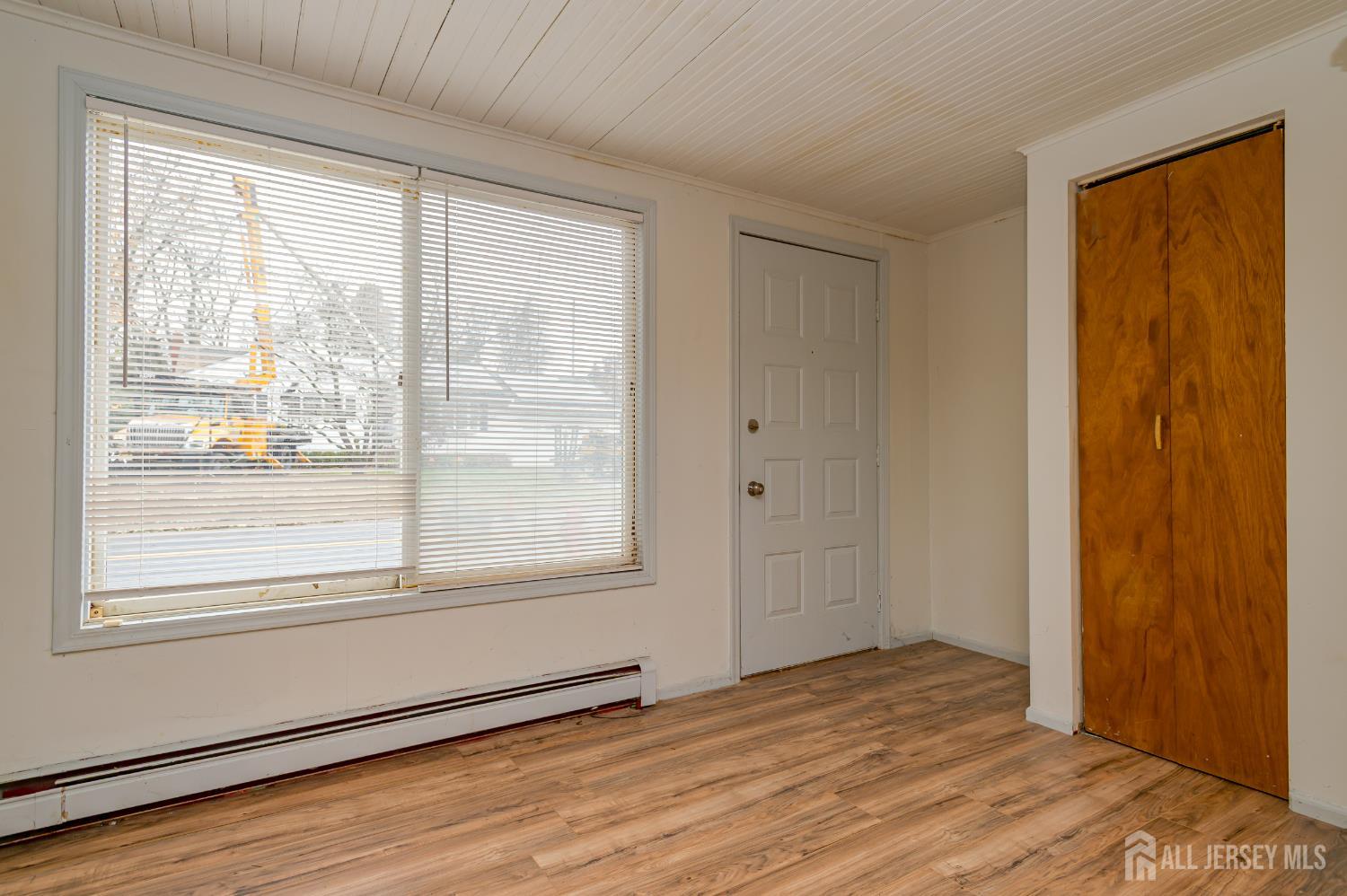 205 Main Street Spotswood, NJ 08884 - Photo 4 of 22 a view of an empty room with wooden floor and a window
