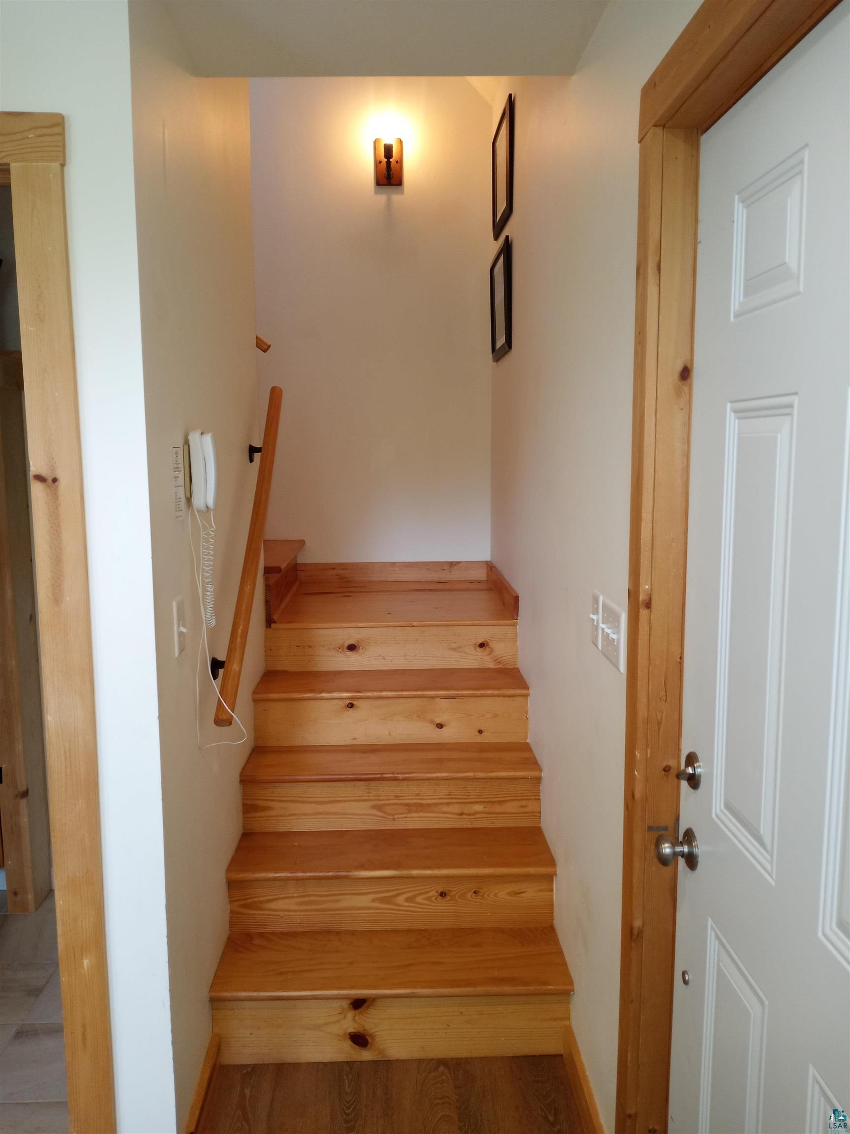 88525 Romans Point Road Herbster, WI 54844 - Photo 10 of 14 Stairs with hardwood / wood-style flooring