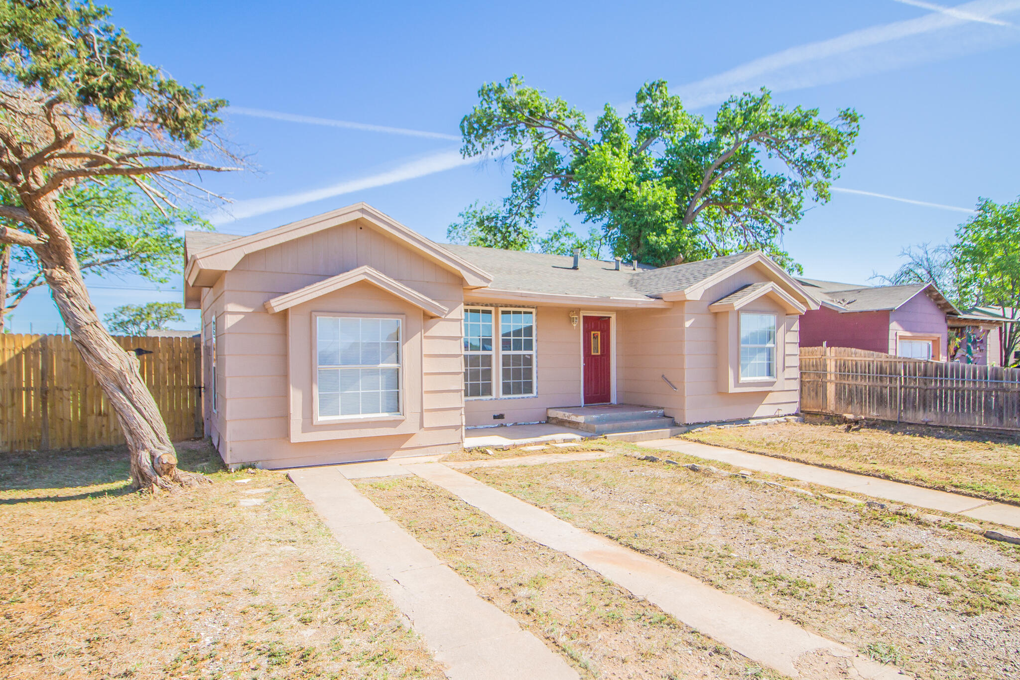 3216 Grinnell Street Lubbock, TX 79415 - Photo 1 of 9 a front view of a house with a yard and garage