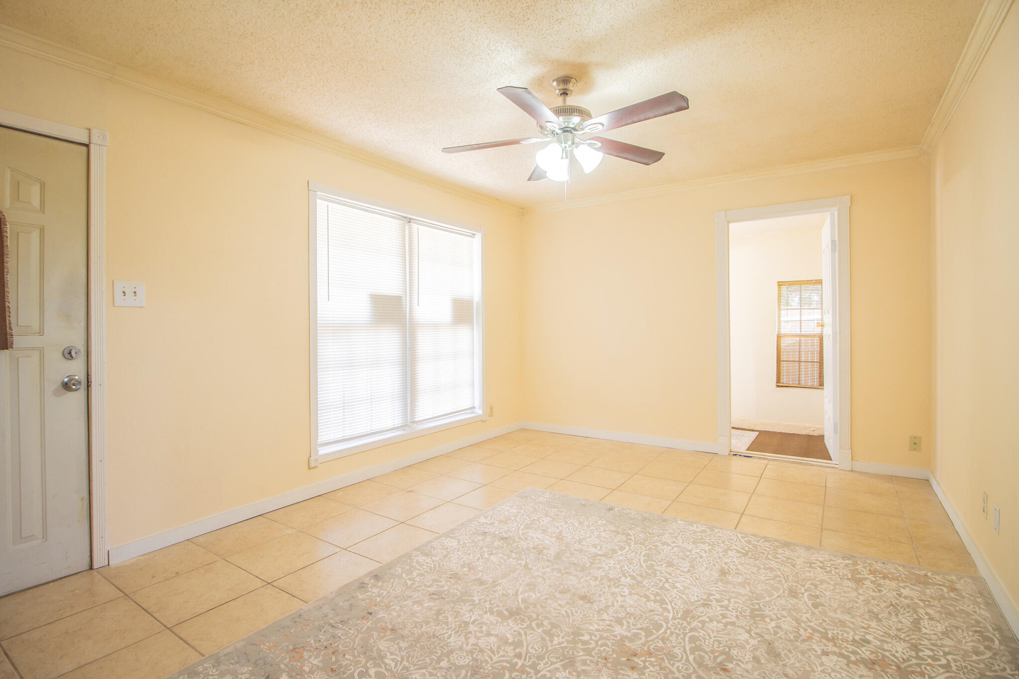 3216 Grinnell Street Lubbock, TX 79415 - Photo 2 of 9 a view of an empty room with chandelier and a window