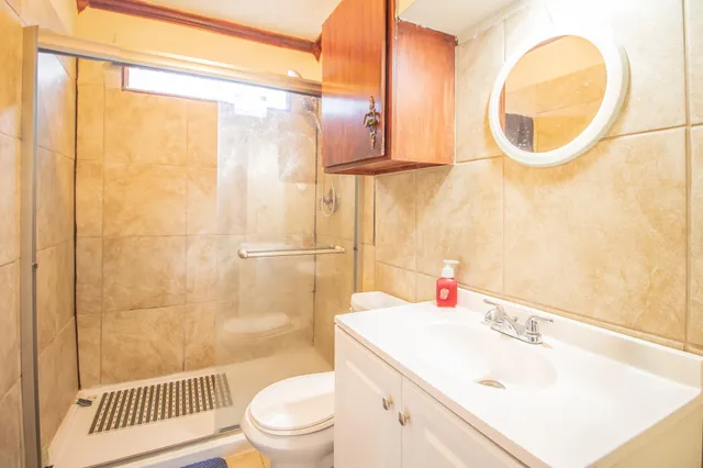 a bathroom with a sink a toilet and shower curtain