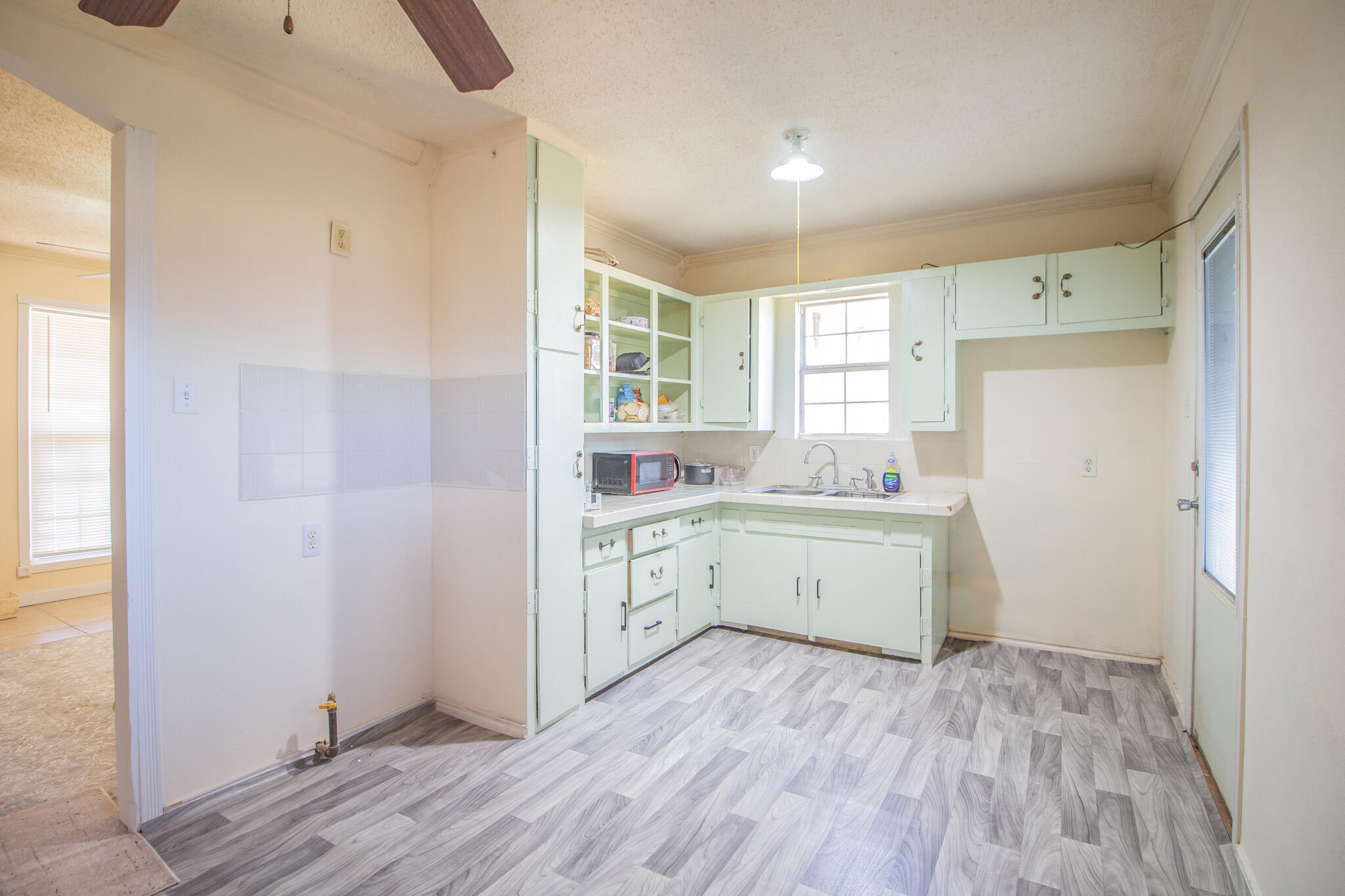 3216 Grinnell Street Lubbock, TX 79415 - Photo 6 of 9 a room with a white stove top oven and refrigerator