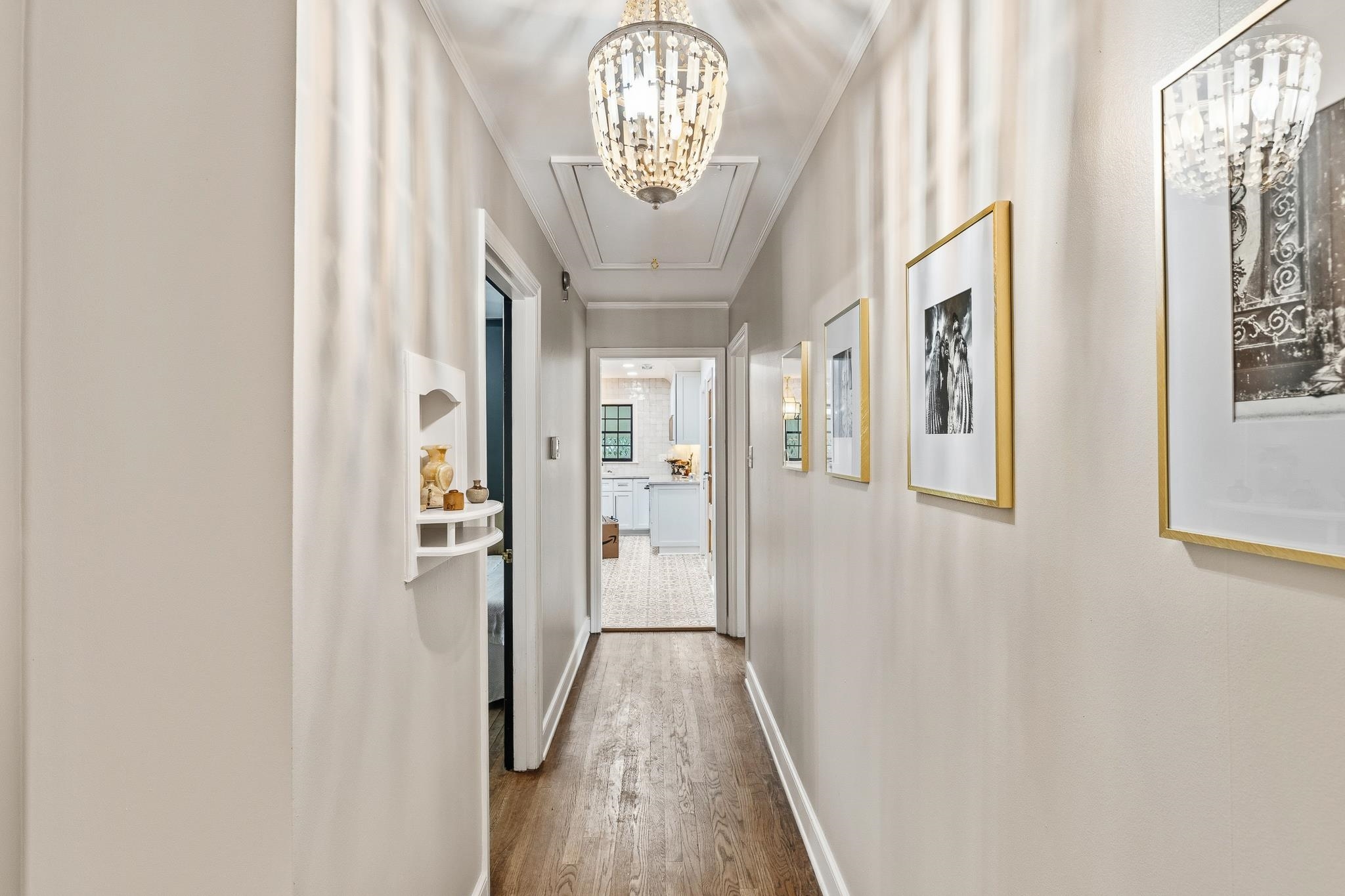 253 Ridgefield Road Memphis, TN 38111 - Photo 23 of 32 Hallway featuring wood-finish flooring and two beaded chandeliers