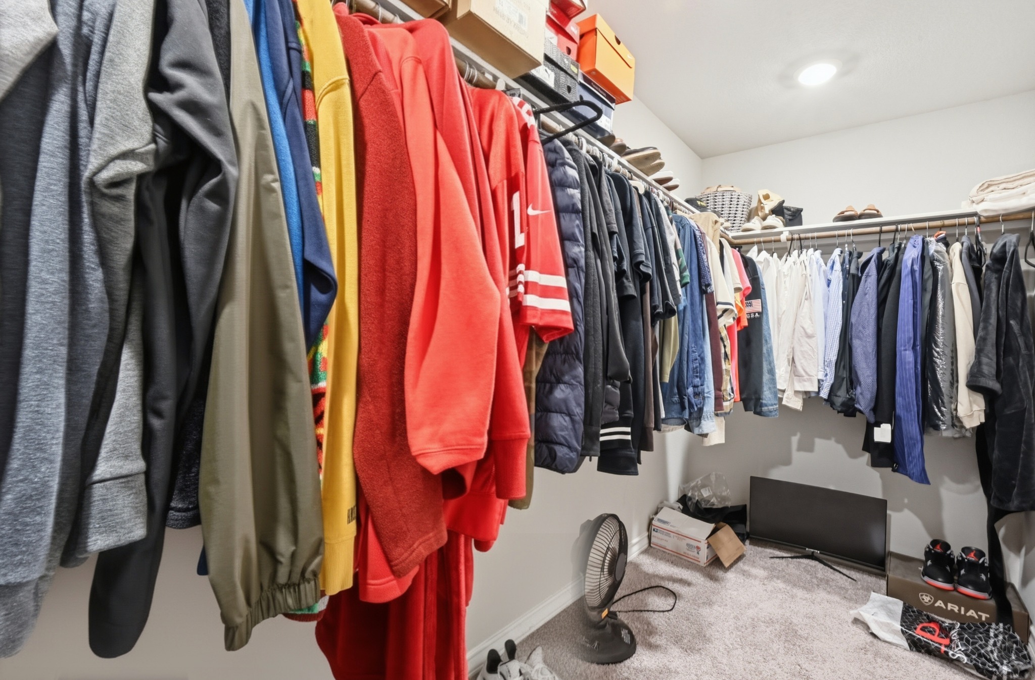 488 Pepperbark Loop Buda, TX 78610 - Photo 21 of 31 Ample hanging space and integrated shelving create an organized wardrobe solution within this functional closet.