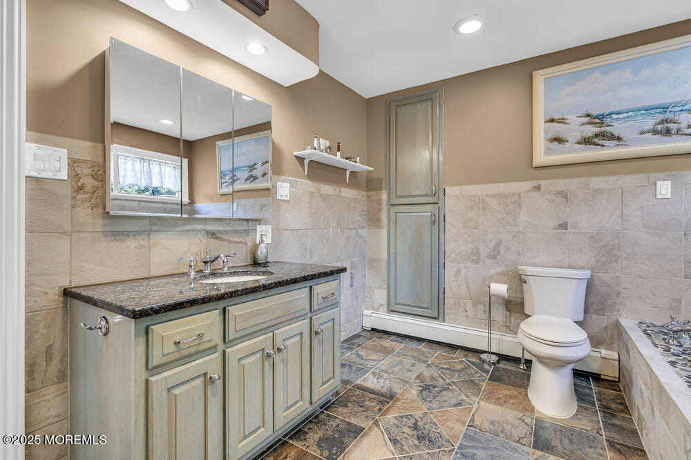 87 Amwell Road Hillsborough, NJ 08844 - Photo 24 of 46 a spacious bathroom with a granite countertop sink a toilet and a mirror