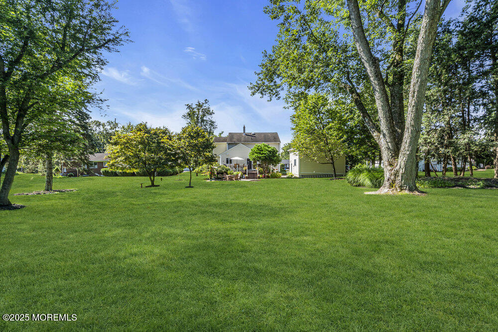 87 Amwell Road Hillsborough, NJ 08844 - Photo 45 of 46 a view of grassy field with benches and trees all around