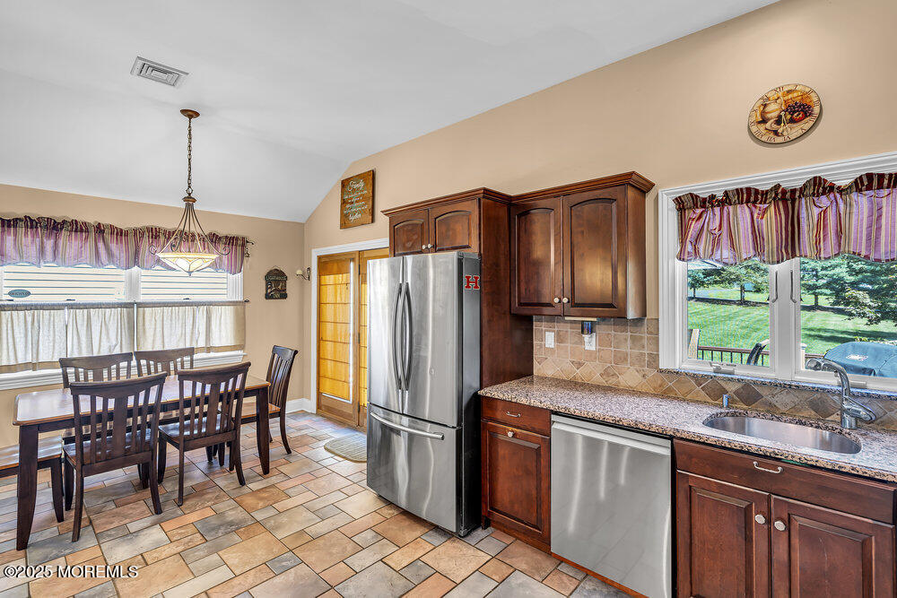 87 Amwell Road Hillsborough, NJ 08844 - Photo 6 of 46 a kitchen with stainless steel appliances granite countertop a refrigerator and a stove top oven