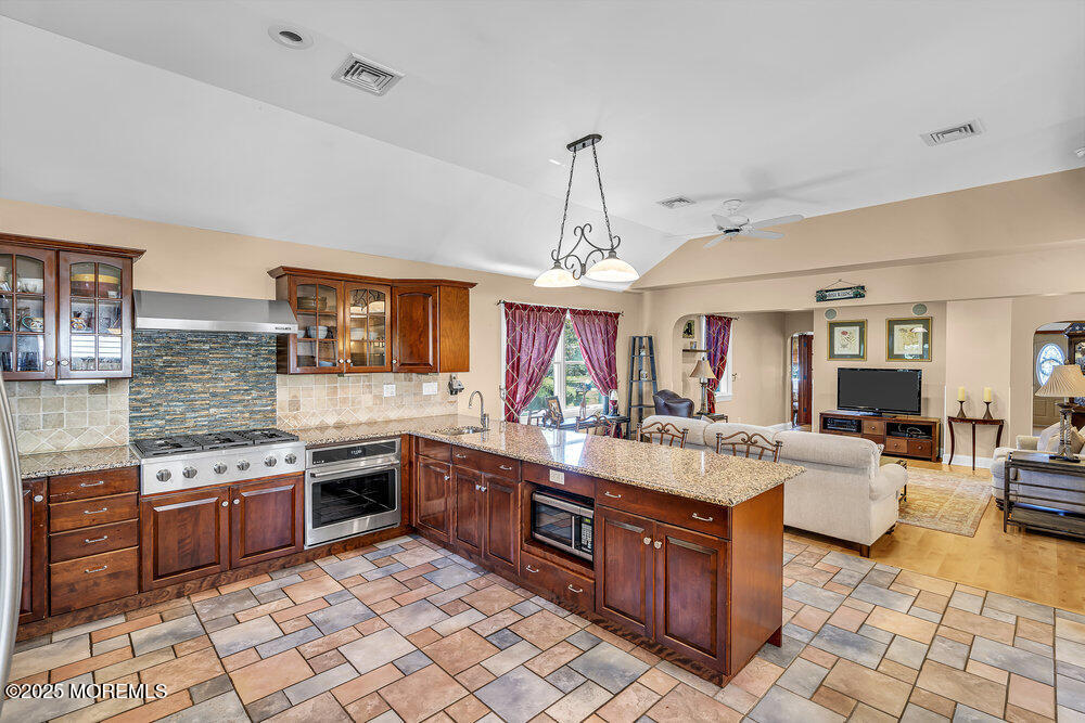 87 Amwell Road Hillsborough, NJ 08844 - Photo 7 of 46 a large kitchen with stainless steel appliances granite countertop a stove granite counter tops and white cabinets