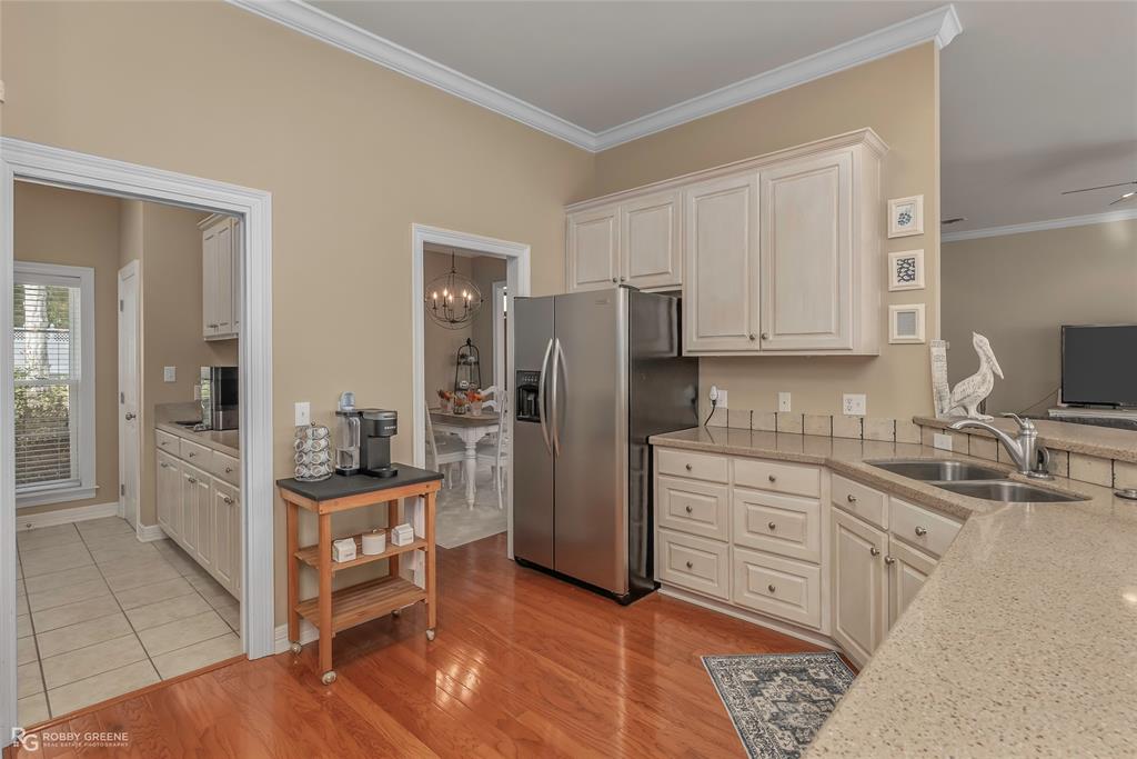 90 La Bella Court Many, LA 71449 - Photo 11 of 38 a kitchen with stainless steel appliances kitchen island granite countertop a refrigerator and cabinets