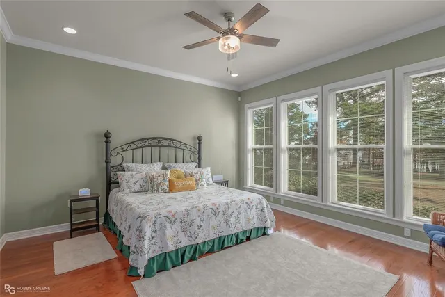 a bedroom with a bed a window and a chandelier