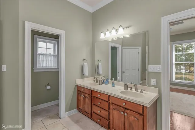 a bathroom with a double vanity sink and a mirror