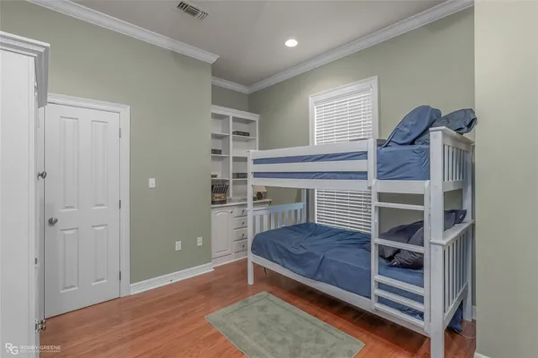 a bedroom with a bunk bed and a window
