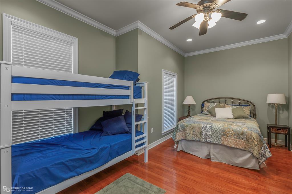 90 La Bella Court Many, LA 71449 - Photo 20 of 38 a bedroom with a bed and a chandelier