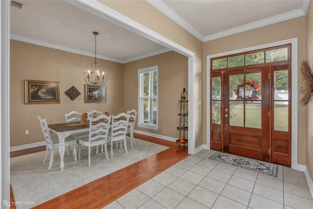 a dining room with furniture a chandelier and window