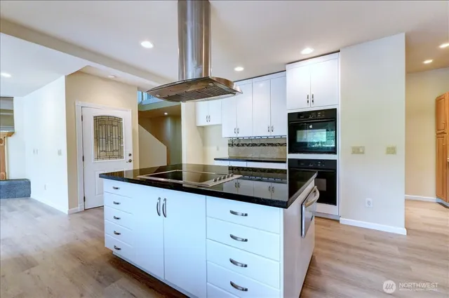 a kitchen with granite countertop a sink and cabinets