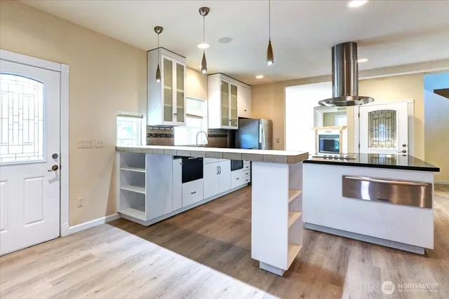 a kitchen with stainless steel appliances granite countertop a stove and a sink
