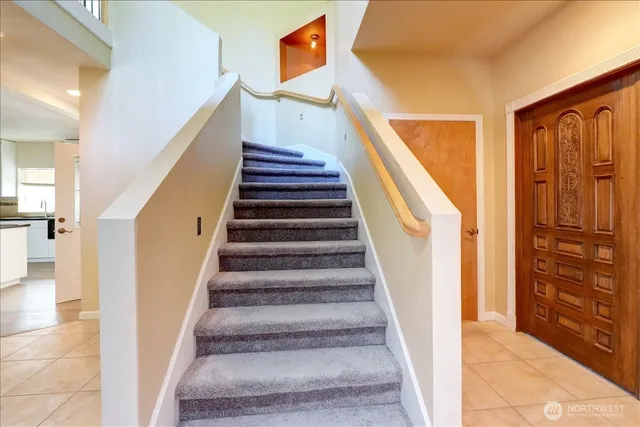 a view of a hallway with windows and stairs