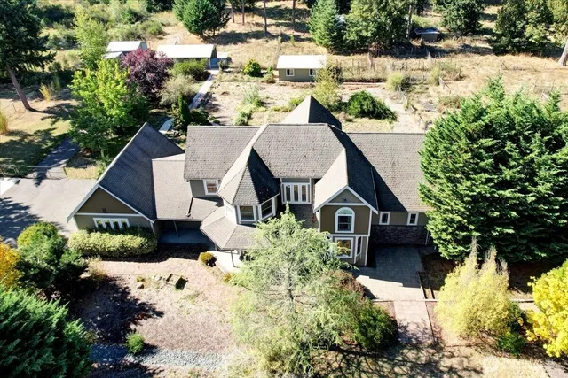 a aerial view of a house with a yard and potted plants