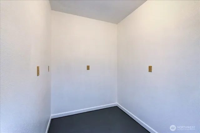 an empty room with a empty space and windows