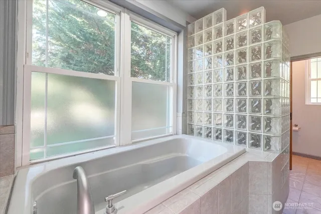 a bathroom with a bathtub and a shower