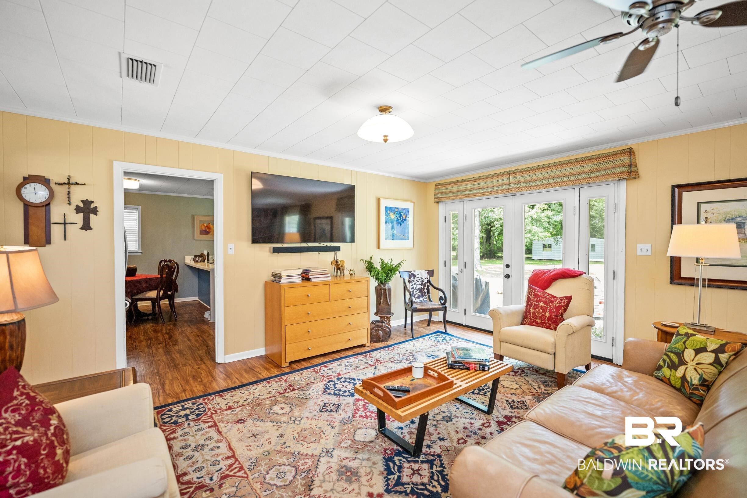 56 Old Bratt Road Atmore, AL 36502 - Photo 7 of 37 Living area featuring crown molding, wood finished floors, a ceiling fan, and baseboards