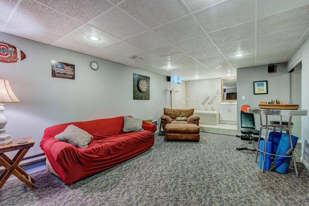 1300 Hubbard Road Galloway, OH 43119 - Photo 48 of 89 • Sculpted carpet • Grey painted walls • Acoustic ceiling tiles • Can lighting • Wall speakers remain • Closet with double sliding doors