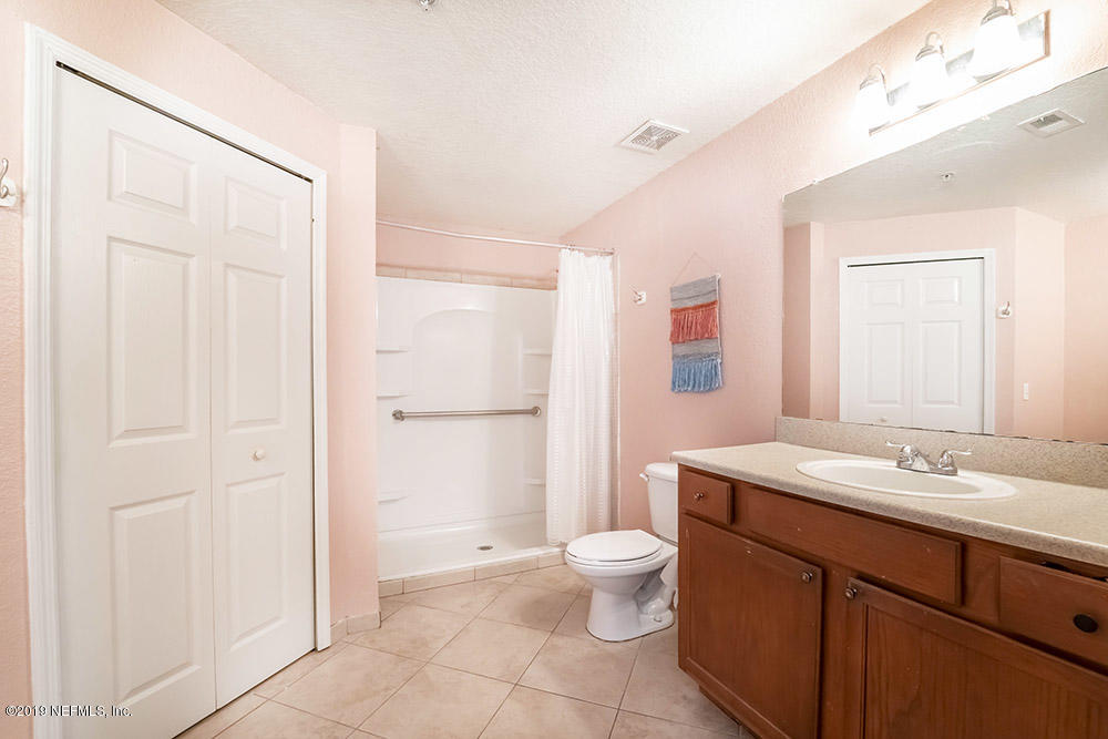 8550 Touchton Road, Unit 218 Jacksonville, FL 32216 - Photo 13 of 29 a bathroom with a sink a toilet and shower