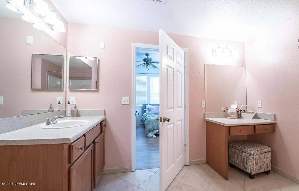 8550 Touchton Road, Unit 218 Jacksonville, FL 32216 - Photo 14 of 29 a bathroom with a sink and a mirror