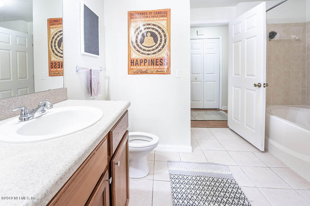 8550 Touchton Road, Unit 218 Jacksonville, FL 32216 - Photo 17 of 29 a bathroom with a sink a toilet and shower